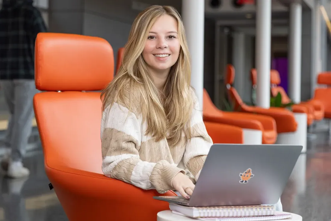 Leana Genovese sitting and smiling.